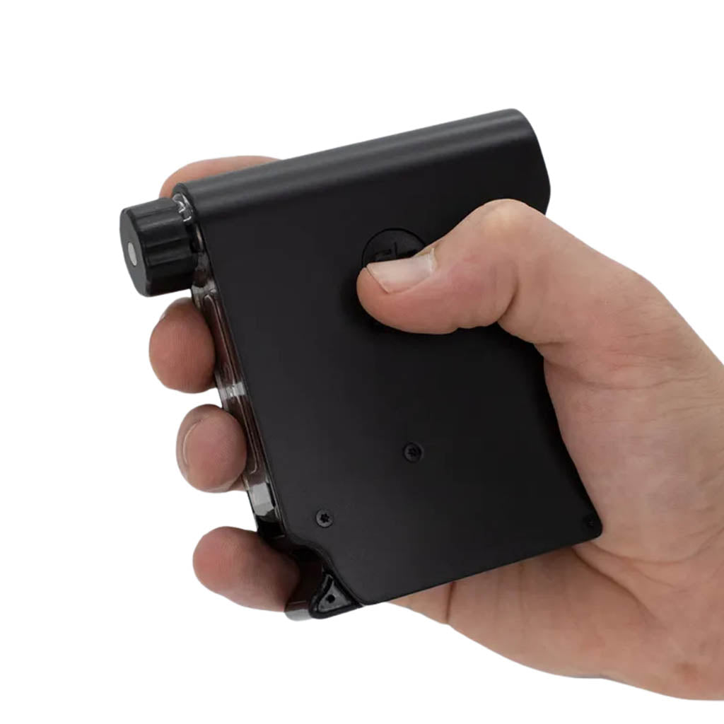 A hand holding the Chewy G3 Deluxe Electronic Grinder, showcasing its compact and ergonomic design.
