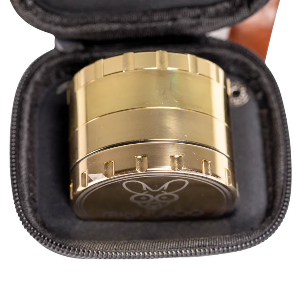 Gold edition of the MightyROO Fifth Edition Grinder securely packed inside its zippered travel case.
