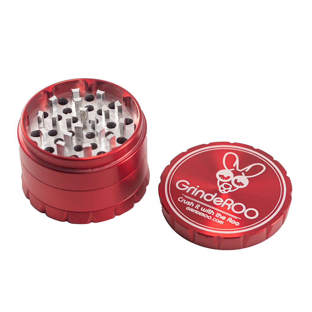 Red GrindeROO OG 4-part herb grinder with lid open, displaying sharp aluminium grinding teeth and durable metal construction.