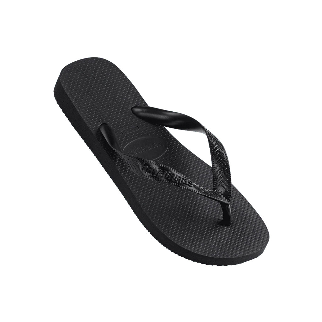 Angled view of black Havaianas Top Thongs displaying the logo on the strap.