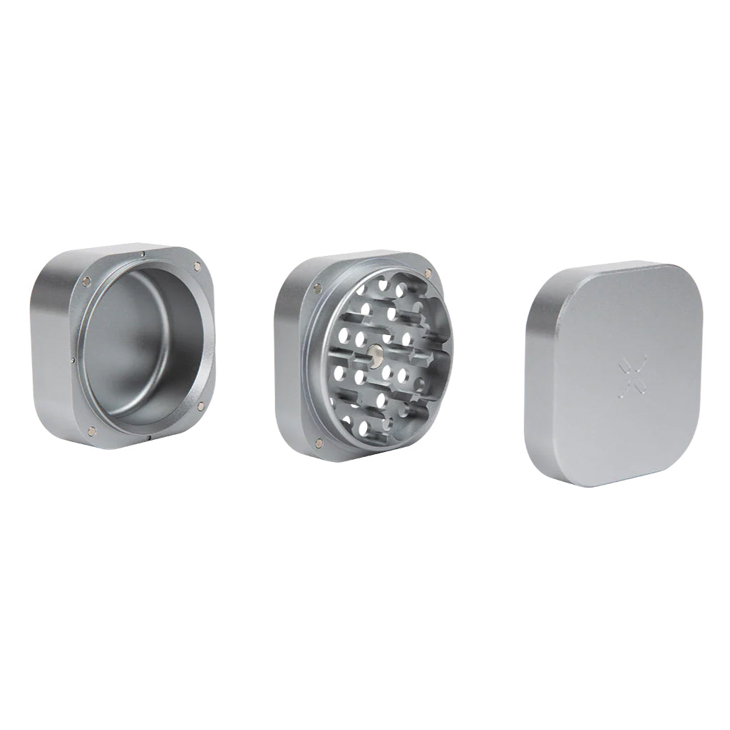 The silver 3 Piece Heavy-Duty Aluminum Grinder displayed in three separate components: lid, grinding chamber with diamond-shaped teeth, and herb collection base.